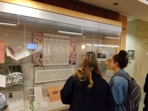 Students viewing library exhibit