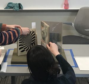 Students making adjustments to exhibit objects