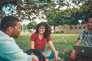 students sitting outside on lawn