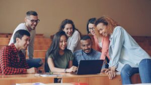 group of students looking at laptop